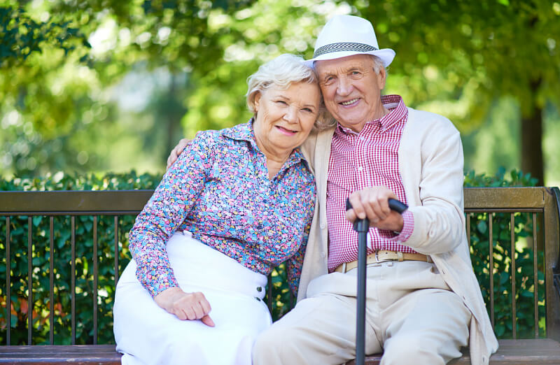 Image of an elderly couple sitting on a bench